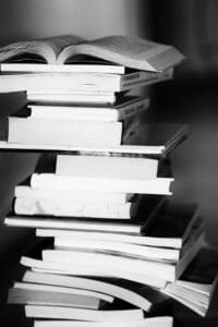 A monochrome image of a tall stack of books symbolizing education and knowledge.