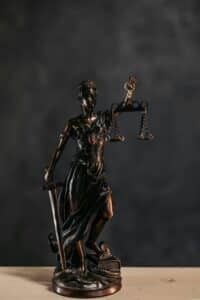 Elegant bronze Lady Justice statuette symbolizing law and justice.
